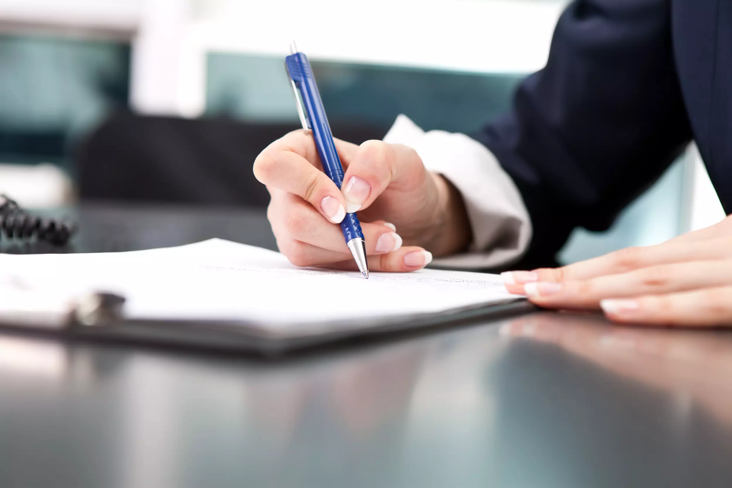 Woman signing paperwork